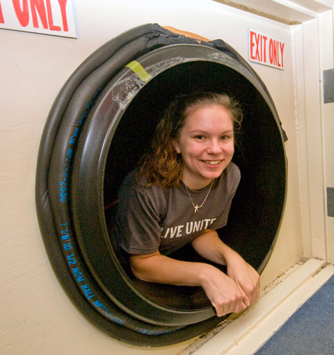 Alyson M. Fields, an accounting student from Marysville, exits the 129-foot tunnel at the YMCA's Children's Discovery Workshop.