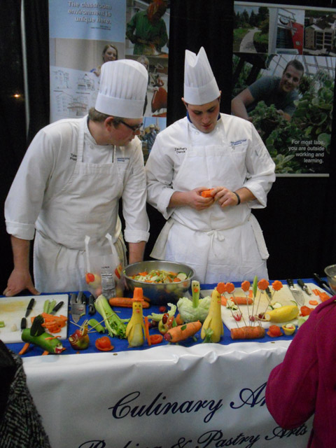 Culinary arts and systems students Tyler K. Pratt (left) and Zachary D. Derck demonstrate the freshness  and playful versatility  of straight-from-the-farm vegetables.