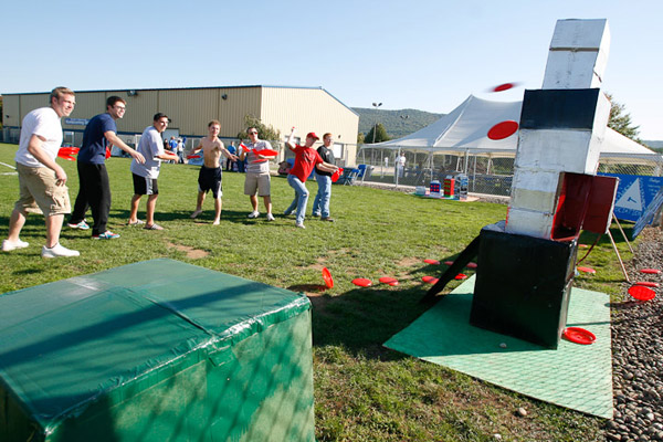 SPE members and friends pummel the club's prize-winning "float" with plastic discs.