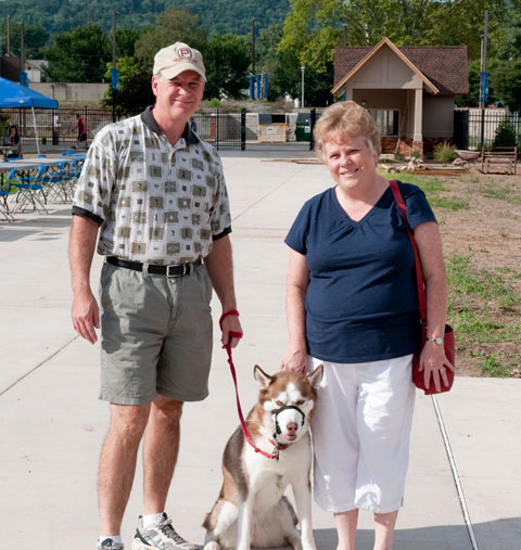 Sheba, a Siberian husky, with owners Raymond J., manager of document services, and Linda J. Fischer, mail services manager.
