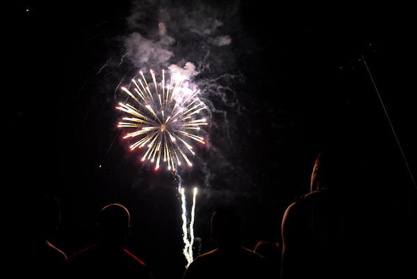 Fireworks silhouette spectators at Thursday's show.