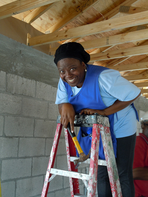Chris, one of the area's newest homeowners, takes a breather after working hard to literally build her future.