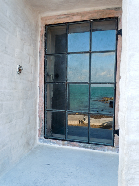A reflection of Biscayne Bay off a lighthouse window