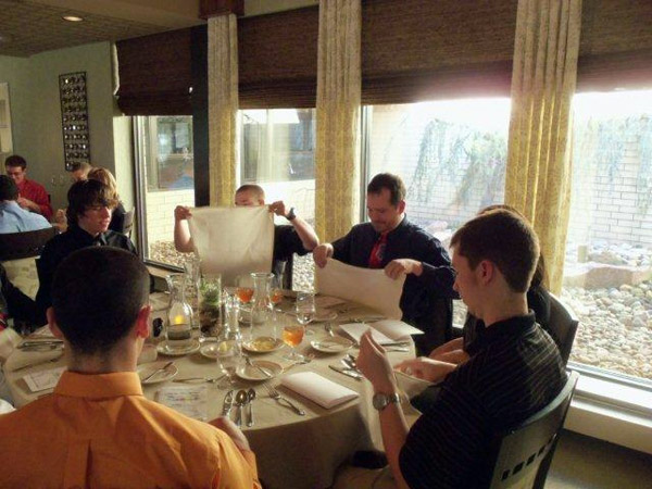 Ian C. Goff, an applied health studies: physical fitness specialist concentration major from Williamsport, learns the proper placement of one's napkin.