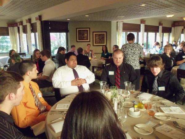 The Phi Mu Delta table, in proximity to returning mentor Debra M. Miller, director of corporate relations (right)