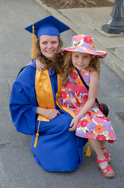Justine J. Bercel, who graduated Friday in early childhood education (and who received the Central Susquehanna Association for the Education of Young Children Award later that night) gets curbside congratulations from daughter Loralie.