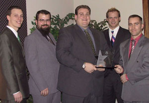 AmerITGrads employees (from left) Christoper J. Suzadail, Jonathan W. Basiago, Daniel R. Little and Robert M. %22Spyke%22 Krepshaw accept the Emerging Business Award from Tim Keohane, director of ther Lock Haven University Small Business Development Center.