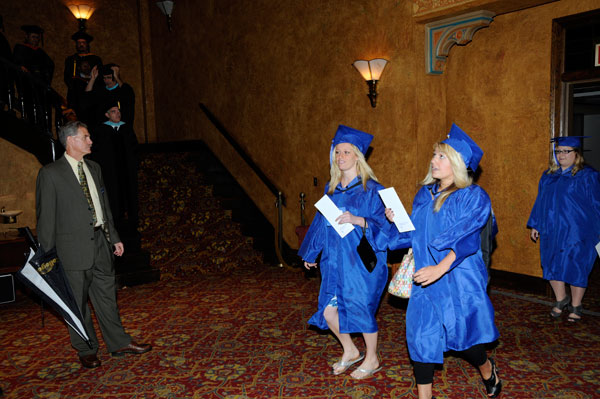 Under the watchful eye of Registrar Denny Dunkleberger, graduating students process to the theater.