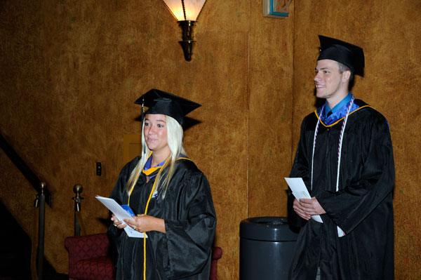 With smiles both broad and contemplative, rising alumni prepare to take their seats.