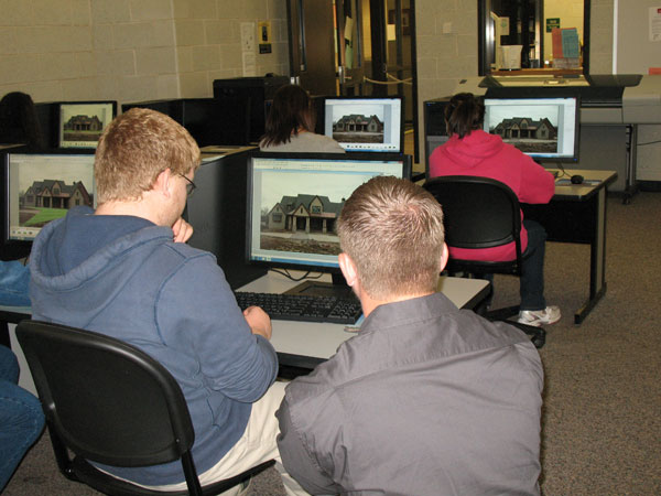 Justin Shelinski, lab assistant for horticulture, assists a student using computer-aided drafting software to design a landscape. 