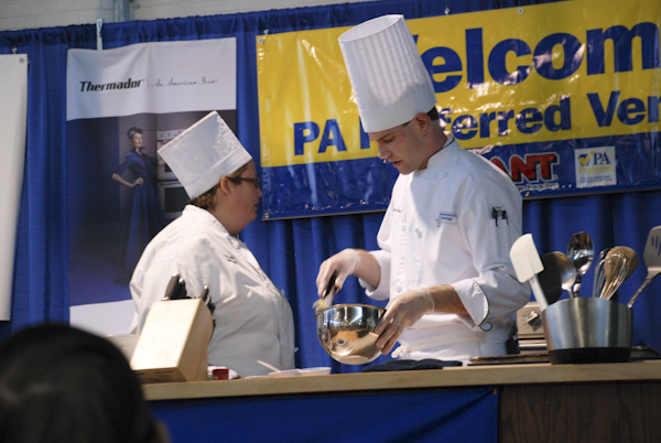 Michelle Mierwald, a culinary arts technology student, and Chef Charles R. Niedermyer, instructor of baking and pastry arts/culinary arts, prepare a blue cheese and caramelized onion quiche with apple slaw.