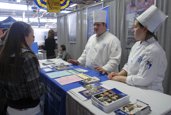 Justin Albert, culinary arts technology, and Tiana Soles-Ahner, baking and pastry arts, talk with a prospective Penn College student.