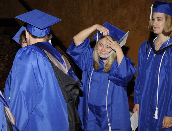 A student makes a last-minute adjustment for her big day.