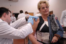 Student administers flu shot at Campbell Street Center.