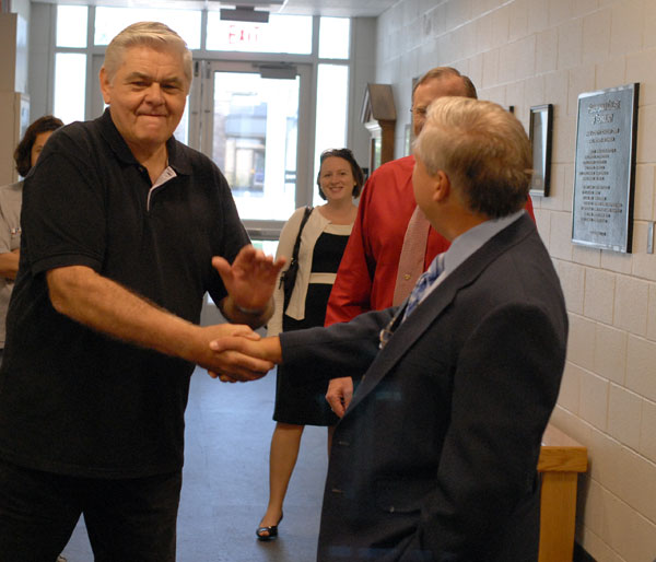 William C. Frick, Williamsport Technical Institute alumnus and former automotive instructor, shares a hearty greeting with Colin W. Williamson, dean of transportation technology.