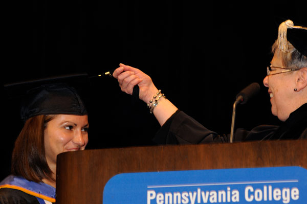 President Gilmour turns the tassel of Alyssa J. Giedroc, making official the transition from student to alumnus.