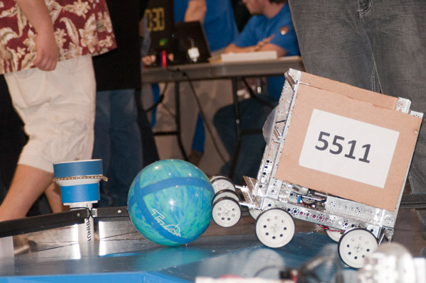 The robot of Gear Up from Edison High School in Philadelphia pushes a bowling ball up its ramp.