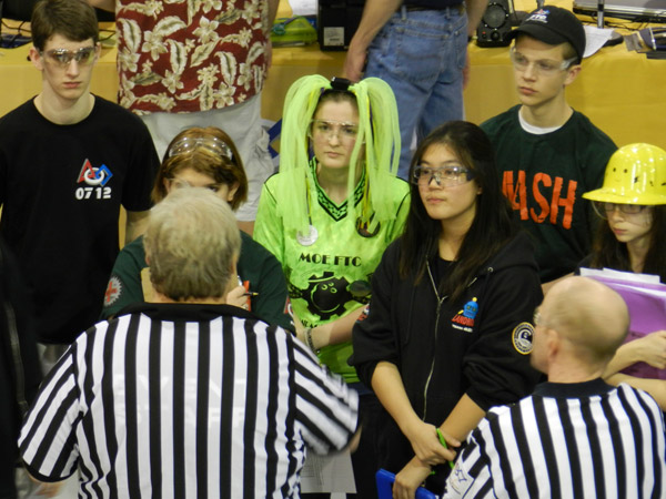 Referees confer with team representatives prior to final matches.