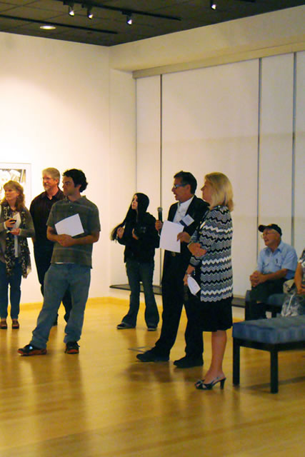 Alumni artist Richard Karp (with microphone) stands between Lenore Penfield, director of special events and the gallery, and Matthew Parrish, the Williamsport Sun-Gazette arts and entertainment editor  and prize judge for the exhibit.