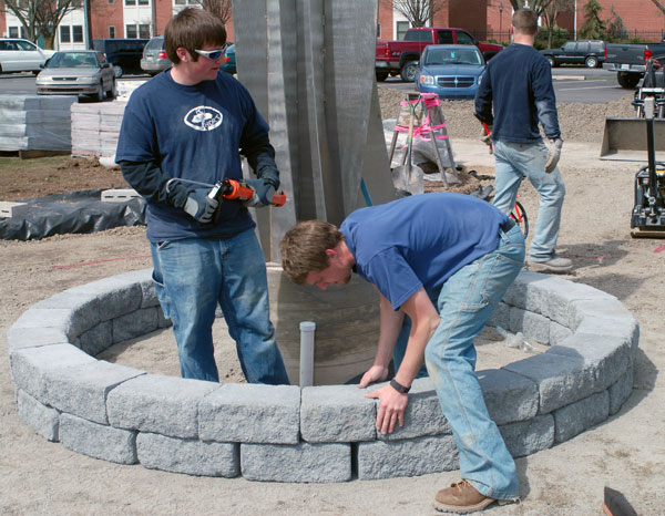 Students of Michael A. Dincher, assistant professor of horticulture, work with alumni to create an expanded Remembrance Garden.