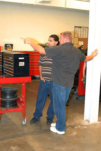 School of Transportation Technology alumni Gilberto Alicea, left, and Ryan Arnold do some wishful thinking about diagnostic equipment they wish was in their respective King of Prussia shops.