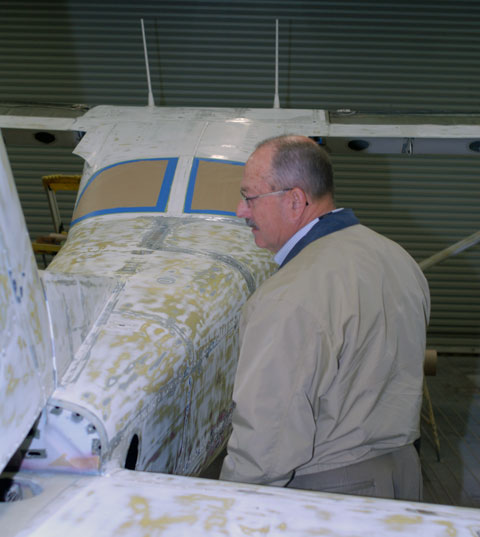 Alumnus Glenn A. Raup, honored in 2002 as a mentor to students, visits the downdraft paint booth at the Aviation Center.