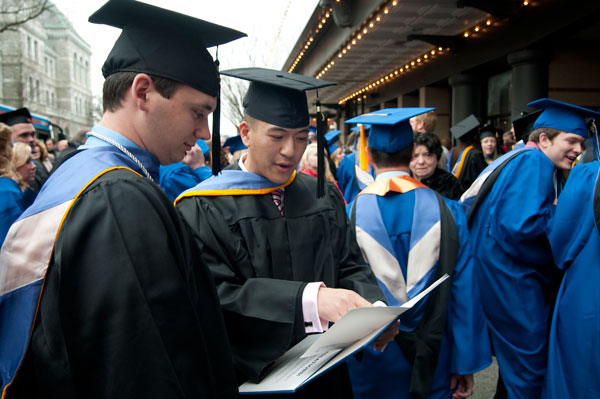 New grads check out their folders.