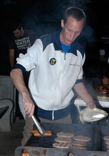 Sigma Nu's Frank Meise prepares another round of free food at Rose Street Apartments.