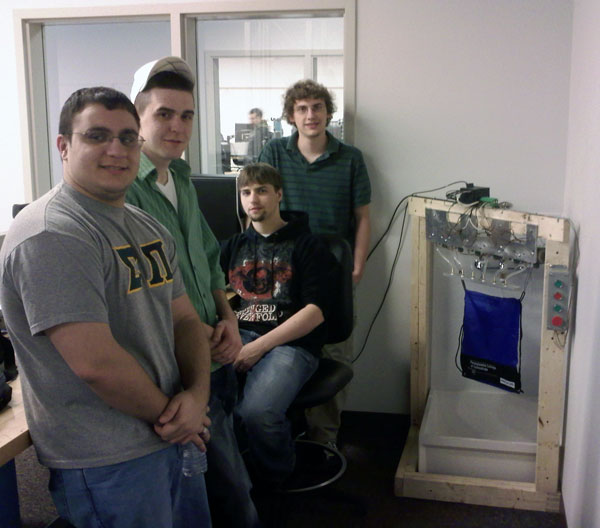 From left, Daniel O. Gomes, Marcus Maceyko, Nicholas L. Orwan and Stephen G. Dumbeck, juniors in the electronics and computer engineering technology program, get ready to demonstrate a Water Sign." The electromechanical system controls water solenoids that fire at specific intervals to display letters and symbols as determined by a matrix output from a Programmable Logic Controller.