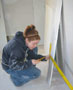 Student Patrice Campbell works on dry wall at 'Habitat' site