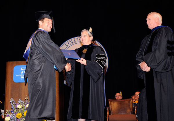 Student speaker Andrew R. Christoffel shakes hands with college President Davie Jane Gilmour.