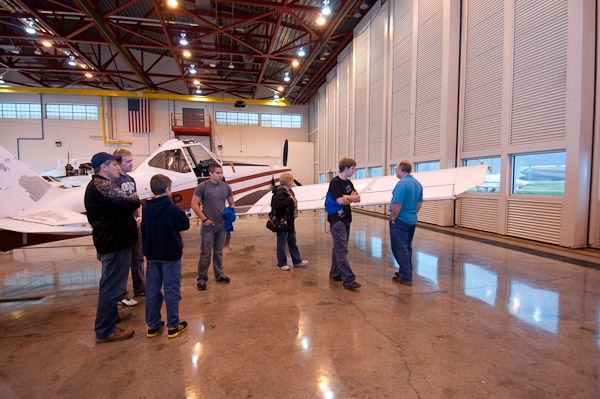 Visitors enjoy a tour of the hangar at the Lumley Aviation Center given by Jessie L. Moore, second from left, an aviation maintenance technology sophomore from Picture Rocks.
