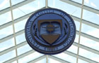 Natural light lends a complimentary backdrop to the suspended Penn College seal