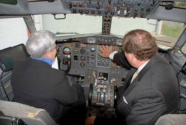 Davie Jane Gilmour, Penn College president, gets a tour of the cockpit from David Sutton, managing director of aircraft acquisition and sales for FedEx. 