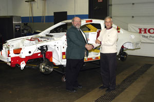 Completing Pennsylvania College of Technology's %22redonation%22 of an instructional-model Acura are Terry Sheaffer, left, collision repair instructor at Columbia-Montour Area Vocational-Technical School, and Colin W. Williamson, the college's dean of transportation technology.