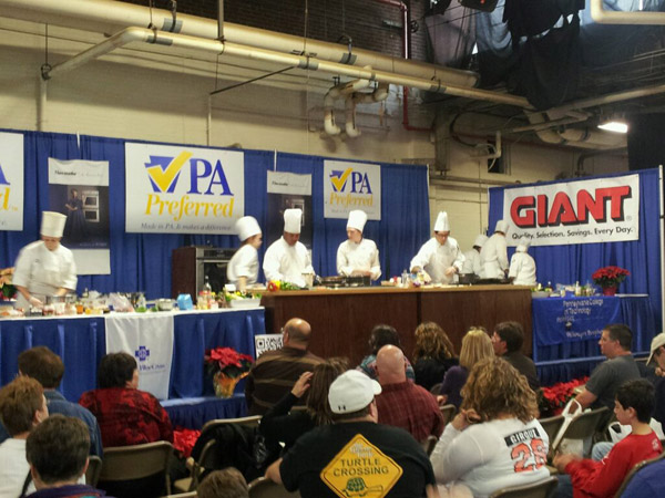 School of Hospitality students, in constant motion on the Department of Agricultures PA Preferred Culinary Connection cooking stage.