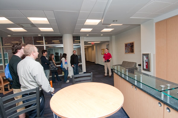 Resident Assistant Adam S. Feather, a senior in building automation technology from Bally, leads a tour group through one of the upstairs common areas in Dauphin Hall. 