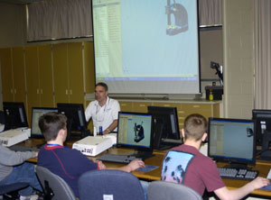 Jeffrey D. Mather, assistant professor of drafting and computer-aided design, shows visiting students how to manipulate a three-dimensional object on-screen.