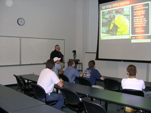 Alfred M. Thomas, associate professor of collision repair, instructs students during I-CAR session.
