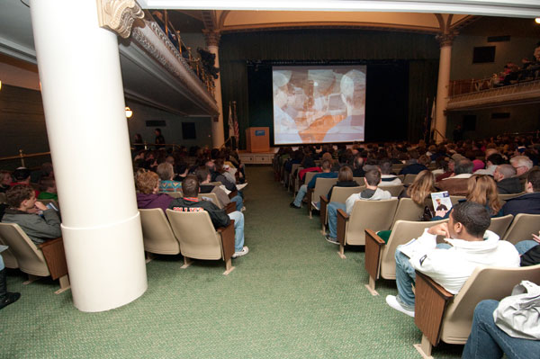 Attendees at an ACC information session watch a college video.
