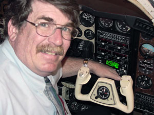 With the lighted avionics panel as a background, Thomas D, Inman sits in the most recent acquisition by the Lumley Aviation Center%3A a 1981 Beech BE-58P Baron.
