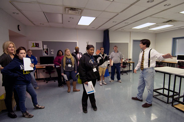 David M. Moyer, instructor of graphic design, walks a group through instructional space in the School of Integrated Studies.