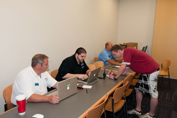 From left, Information Technology Services employees Jim J. Folmar II, coordinator of advanced desktop computing applications; Brandon M. Penglase, technical support analyst; and Ron Z. Miller, director of academic/desktop computing and audio/visual services, provide student assistance.