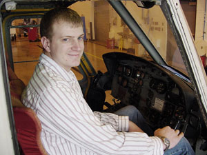 Jason M. Smith sits in a Bell UH-1B 'Huey' helicopter at Penn College's Lumley Aviation Center.