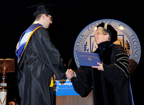 John R. Greenwood, Harrisburg, who earned degrees in manufacturing engineering technology, toolmaking technology and automated manufacturing technology  in addition to the Board of Directors' Award  greets President Gilmour.