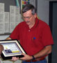 John J. Macko admires certificate of appreciation from students