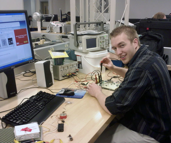 Joseph M. Van Noy, a junior in the electronics and computer engineering technology program, with his project that uses a modulated laser beam to send music to a plasma speaker.