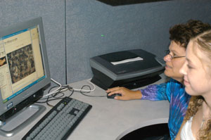 Judith Coleman and her cousin, Kasey L. Roedts (a Penn College student) view online photos of Katrina's destructive force.