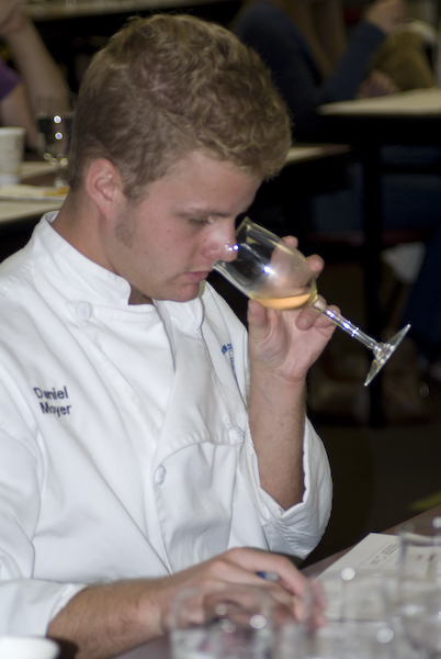 Daniel Moyer, a culinary arts student in the Wines of the World class, tests the aroma of a German wine during a visit by viticulture expert Klaus Wahl. 