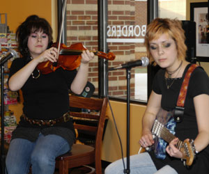 Erin M., left, and Valerie A. LaCerra, both of Linden, perform during a reception where the book jacket winners were announced.